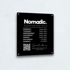 Black acrylic sign with customised design for a clothing company called Nomadic, includes a scannable QR code and opening times