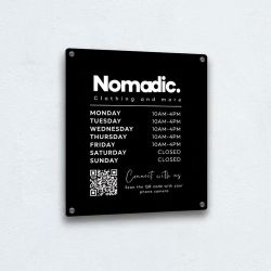 Black acrylic sign with customised design for a clothing company called Nomadic, includes a scannable QR code and opening times