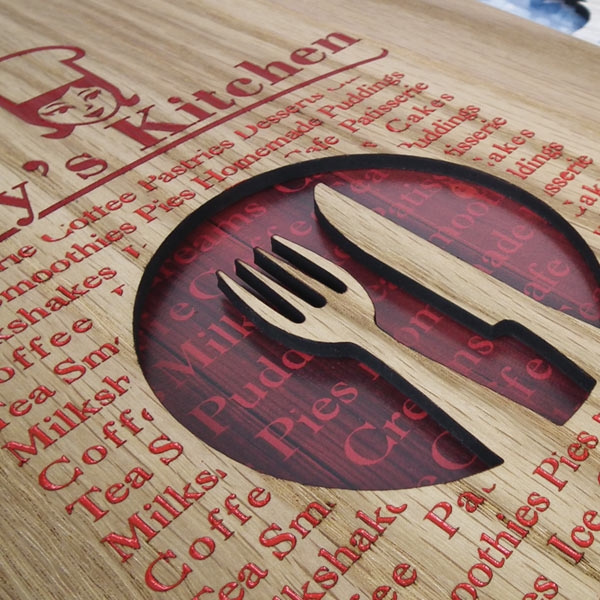 Wooden menu cover with a cut-out logo